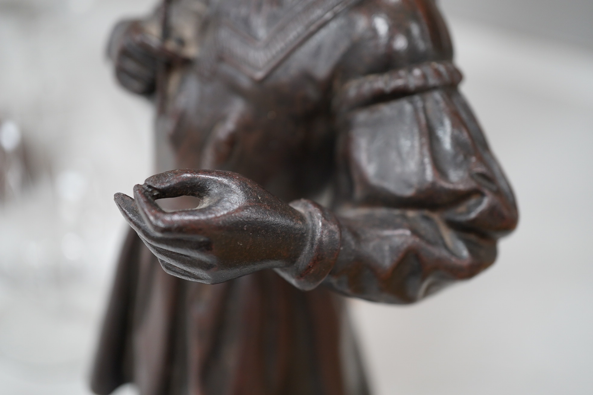 A cast iron figure of a scribe, with bronzed patina, 33cm high. Condition - good